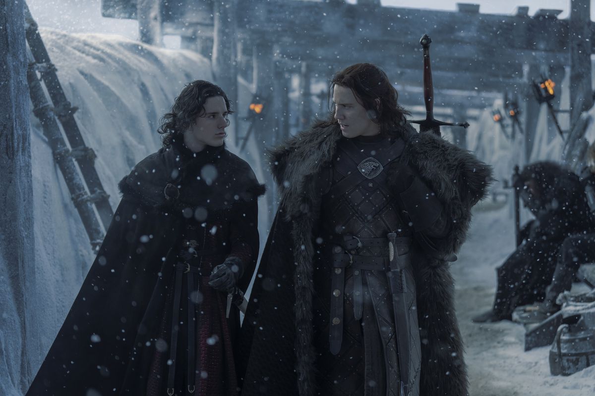 Jacaerys (Harry Collett) and Cregar Stark (Tom Taylor) standing and talking on the Wall